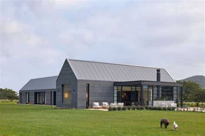 Who developed farmhouse architecture